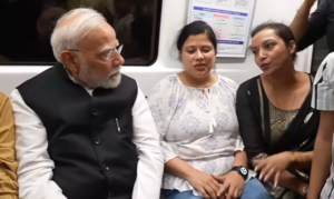 PM Narendra Modi speaks with passengers of Delhi Metro during his travel to SRCC in the train on September 5.